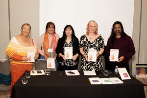 Book panel participants holding their books