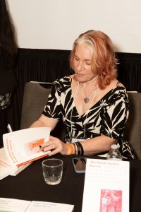 Dr. Eileen O’Brien signing a book at the panel event